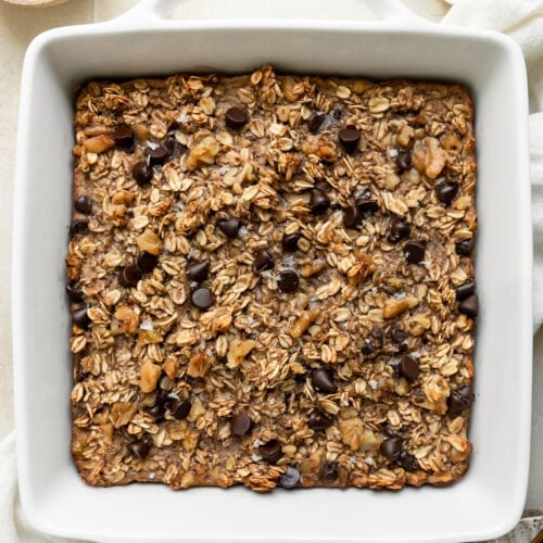 Overhead view banana chocolate chip baked oatmeal in white baking dish
