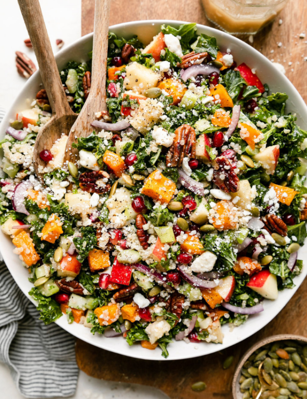 Overhead view harvest quinoa salad with butternut squash in white serving bowl.