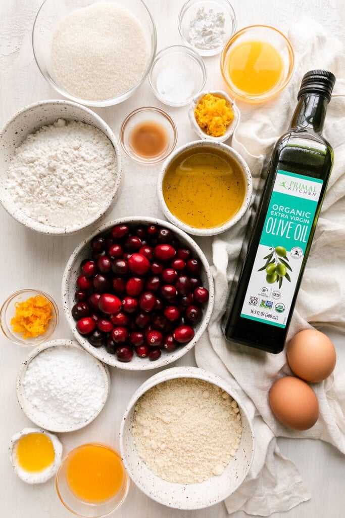 Overhead view all ingredients for cranberry orange olive oil cake.