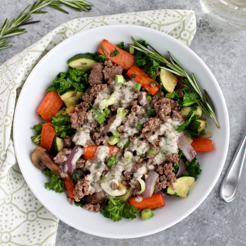 A plate of Ground Meat Veggie Skillet with fresh rosemary on top
