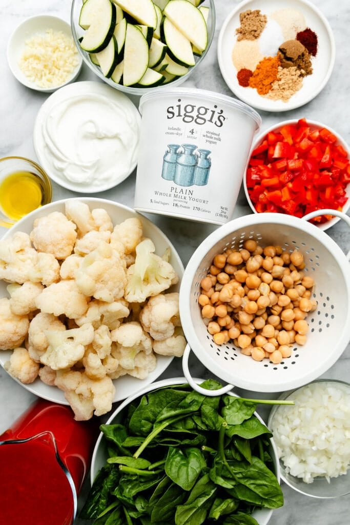 All ingredients for vegetarian tikka masala arranged in small bowls.