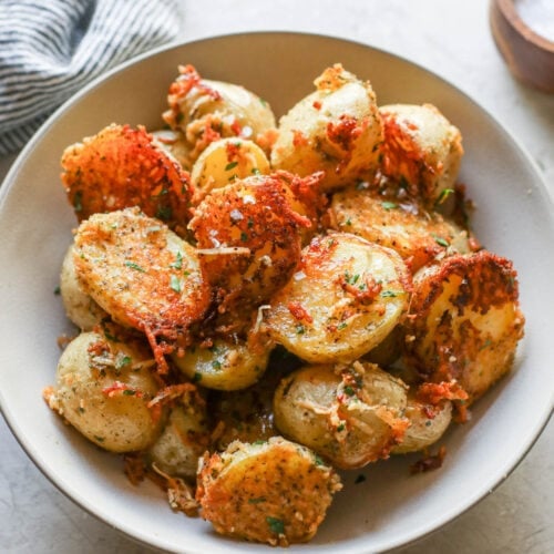 Parmesan crusted potato halves in bowl ready for serving