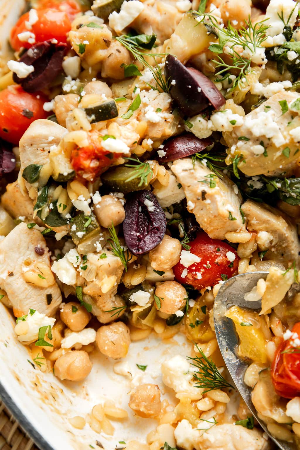 Close up view Greek orzo with chicken, artichokes, and feta cheese
