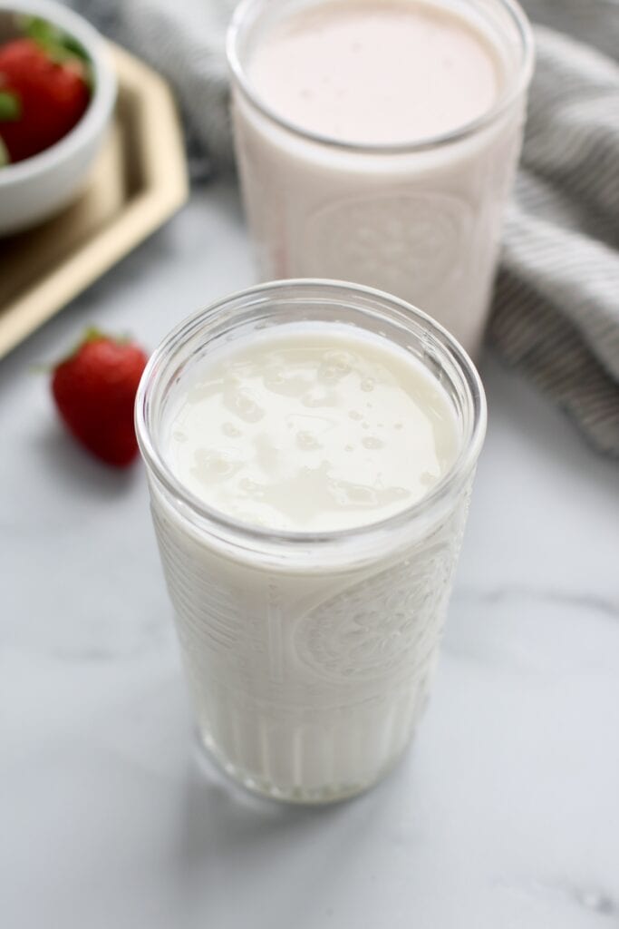 Close up view of two glasses of strawberry kefir.