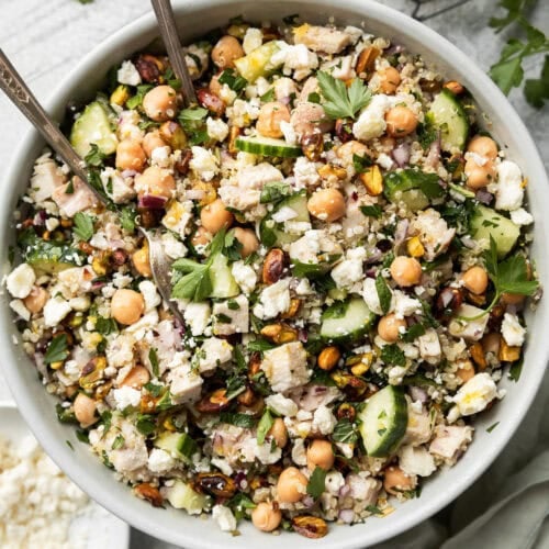 Overhead view Jennifer Aniston salad with chicken and chickpeas in white serving bowl