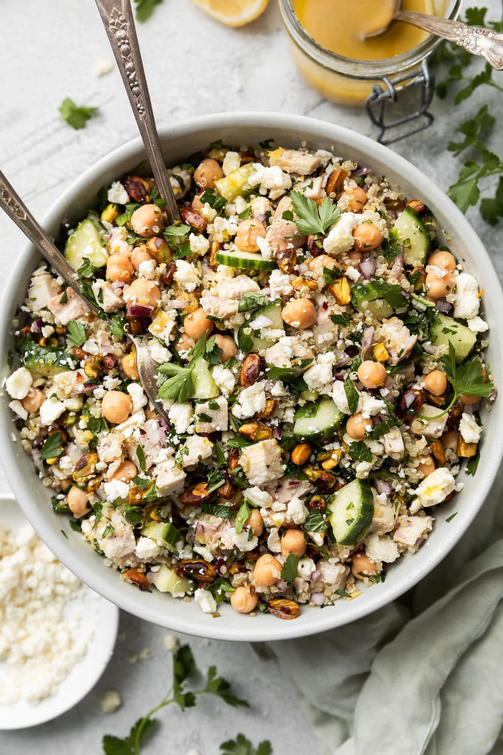 Overhead view of a bowl of Jennifer Aniston Salad topped with fresh herbs and feta crumbles. 