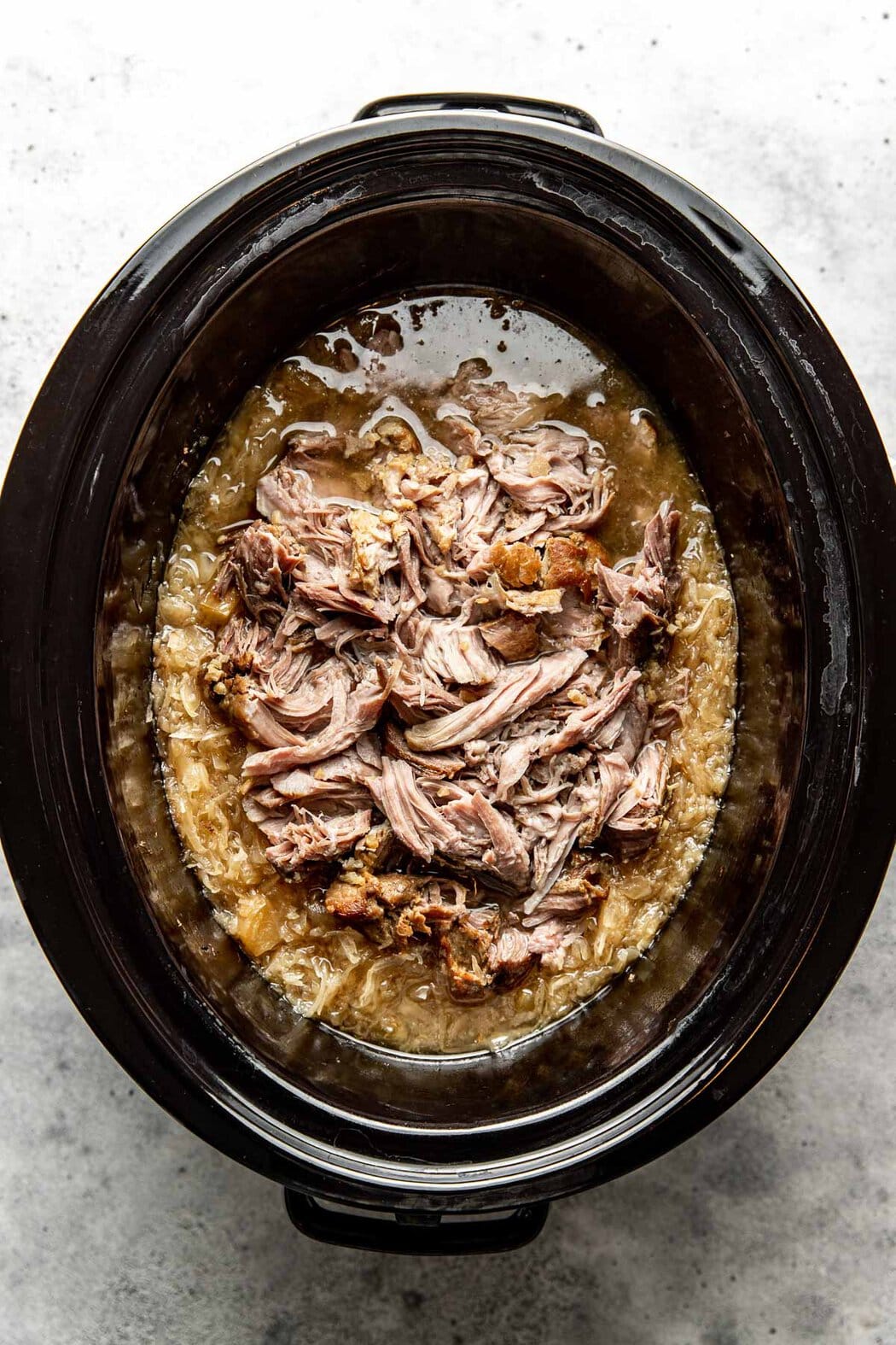 Overhead view of finished Pork and Sauerkraut in the crock pot ready for eating. 