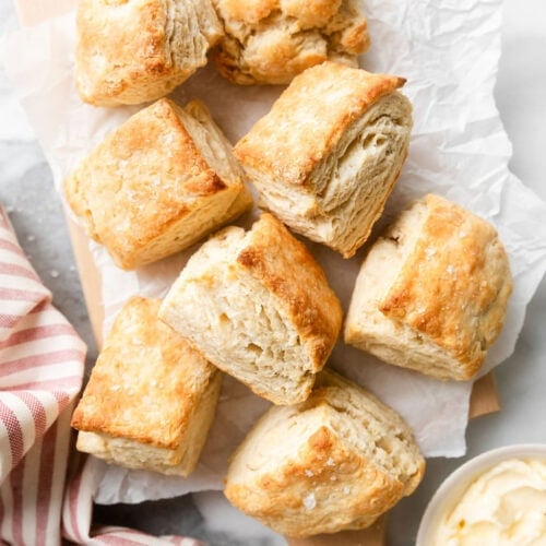 Overhead view homemade flaky biscuits on parchment paper