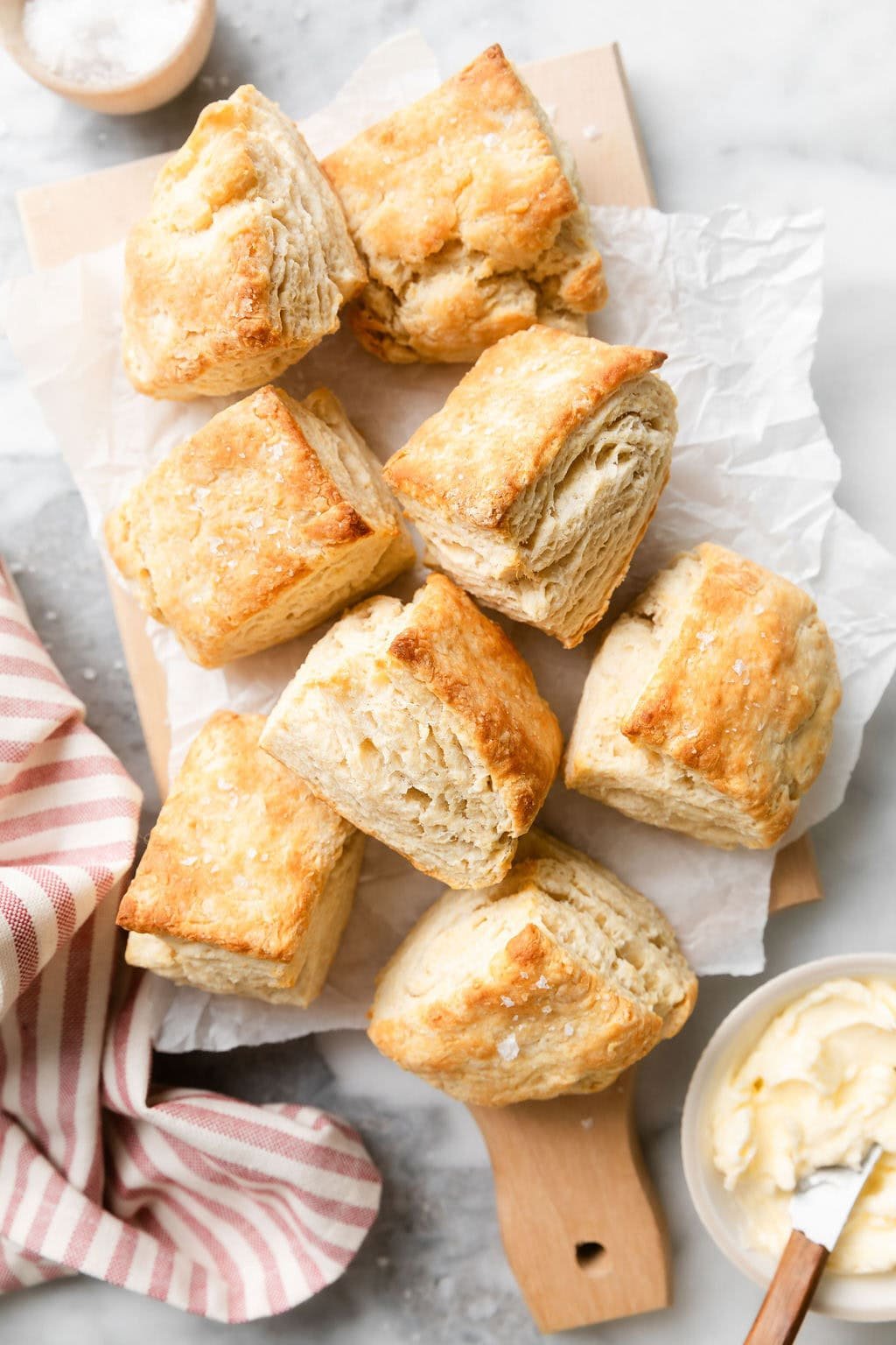Overhead view of freshly baked Biscuits topped with flakey sea salt. 