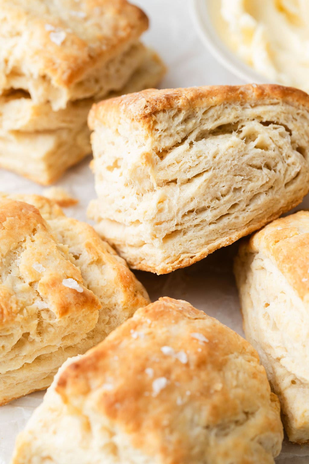Close up view of a freshy baked biscuit, showing the flakey layers. 