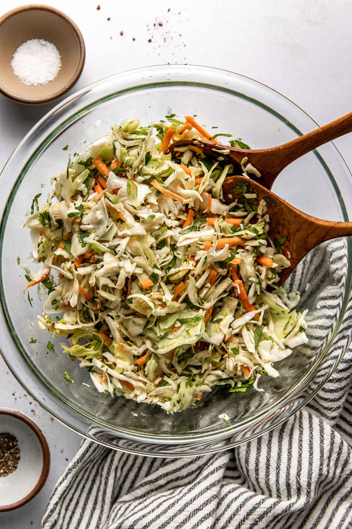 Overhead view of a glass bowl filled with freshly combined Cilantro Lime Slaw. 
