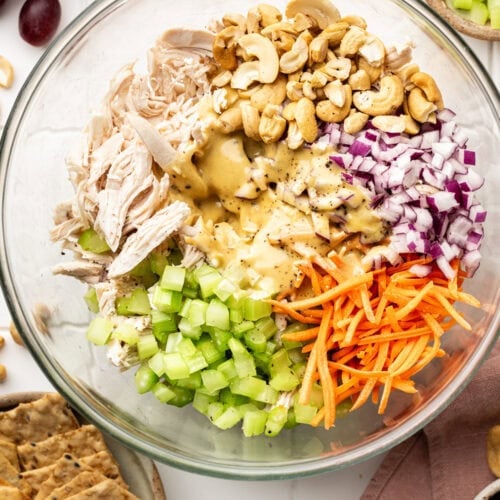 A bowl of ingredients to make honey mustard chicken salad.