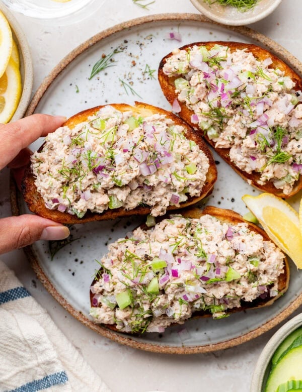 Overhead view of three pieces of French bread, toasted, topped with salmon salad