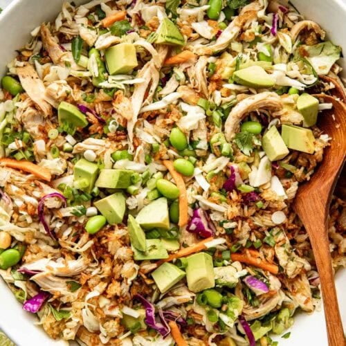 Overhead view of a bowl filled with crispy rice salad with fresh vegetables and topped with edamame.