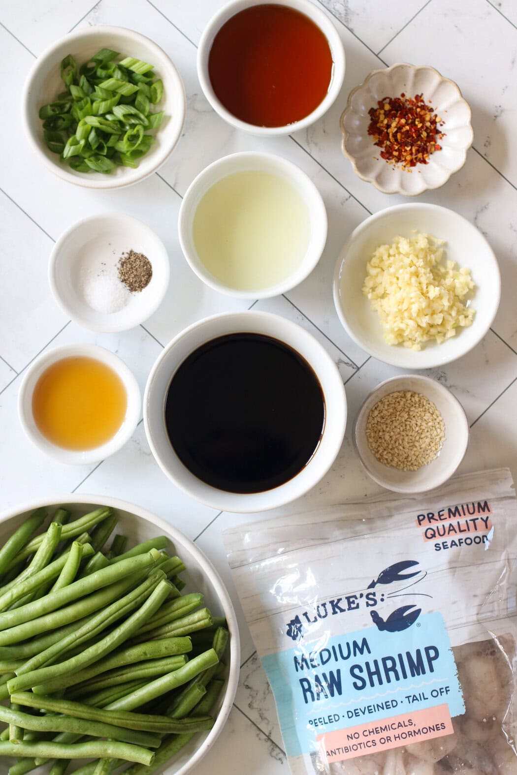 Overhead view of ingredients to make honey garlic shrimp on a sheet pan.