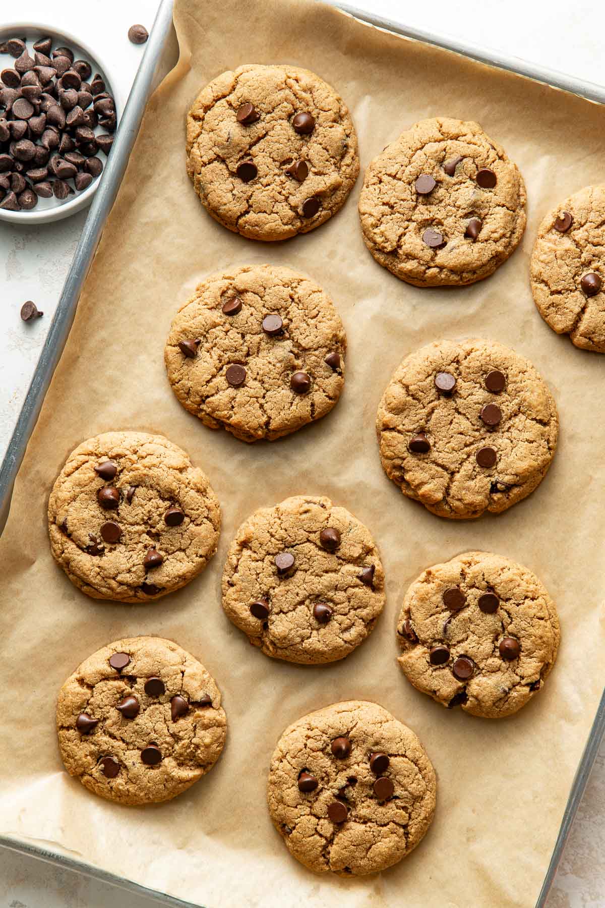 Overhead view of a sheet pan lined with parchment paper topped with freshly baked Protein Cookies.