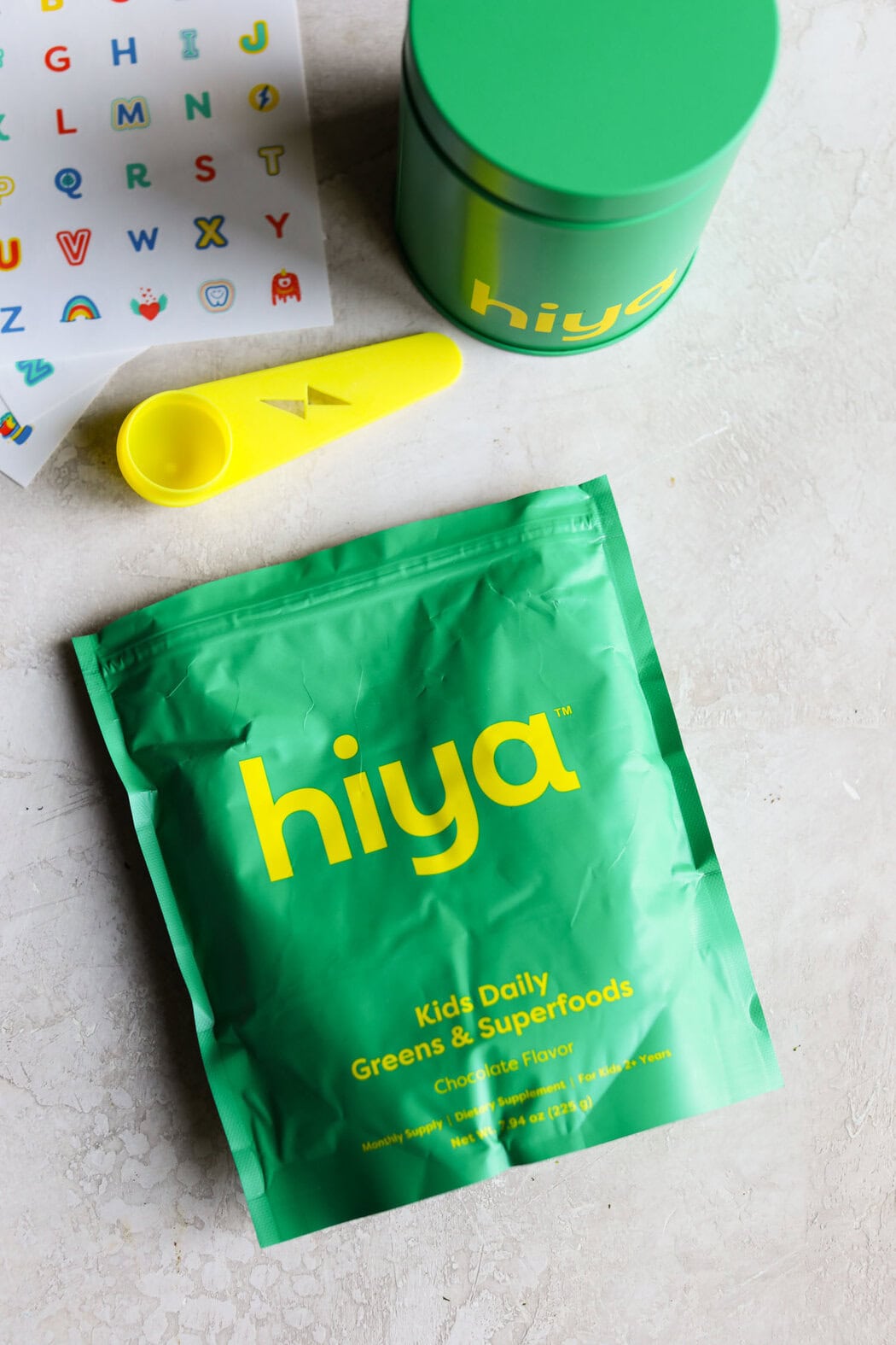 Overhead view of hiya packaging and sticker sheets on a marble countertop.