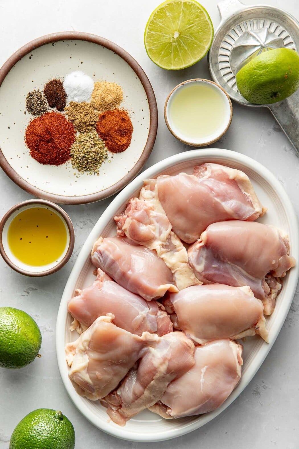 Overhead view of a variety of ingredients for chipotle chicken in different sized bowls.