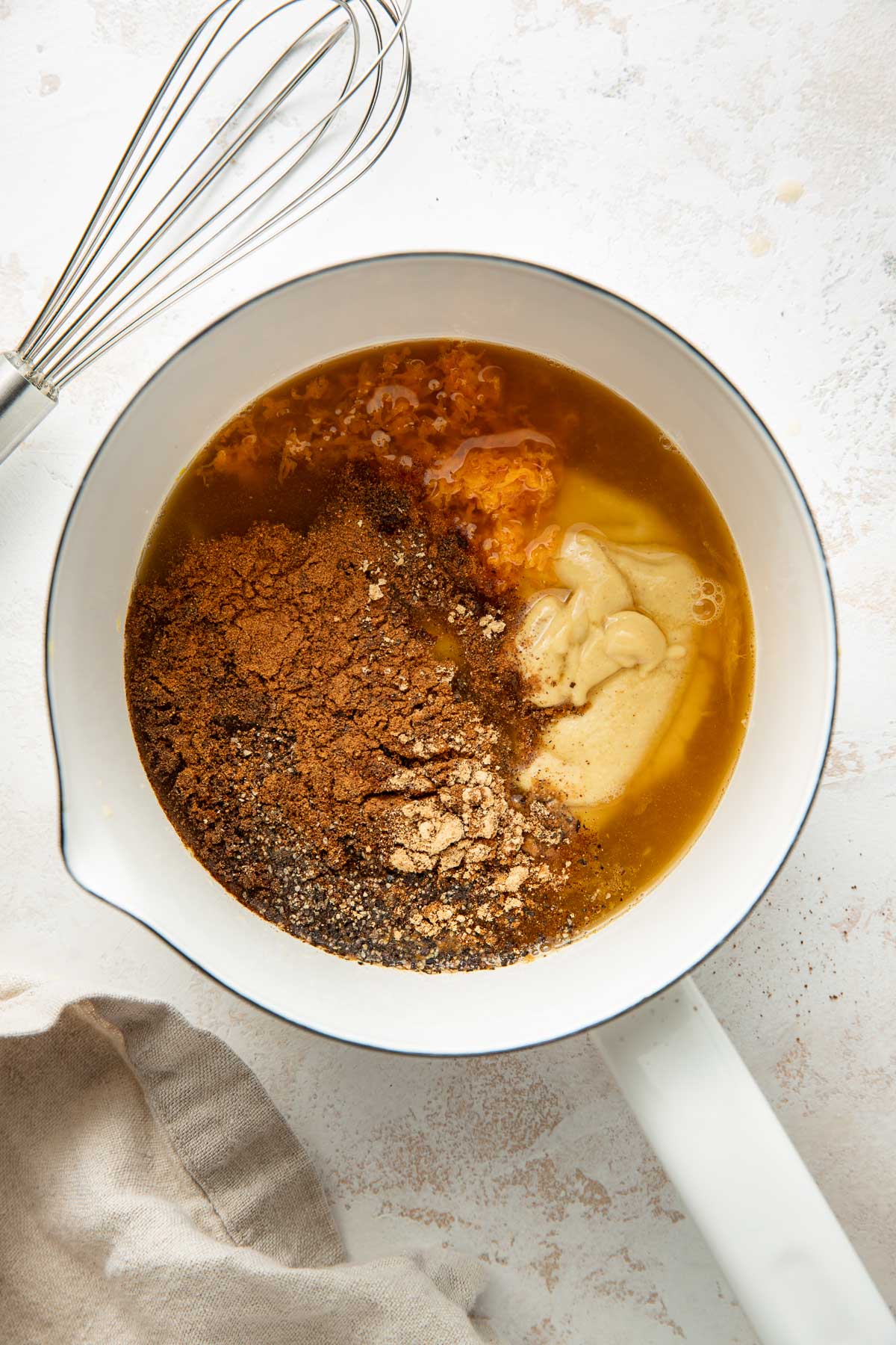 Overhead view of a small saucepan filled with Ham Glaze ingredients ready to be stirred.