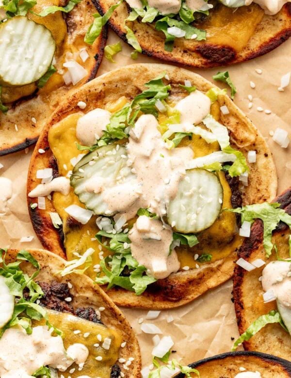 Overhead view of a Smash Burger Taco topped with special sauce and pickles.